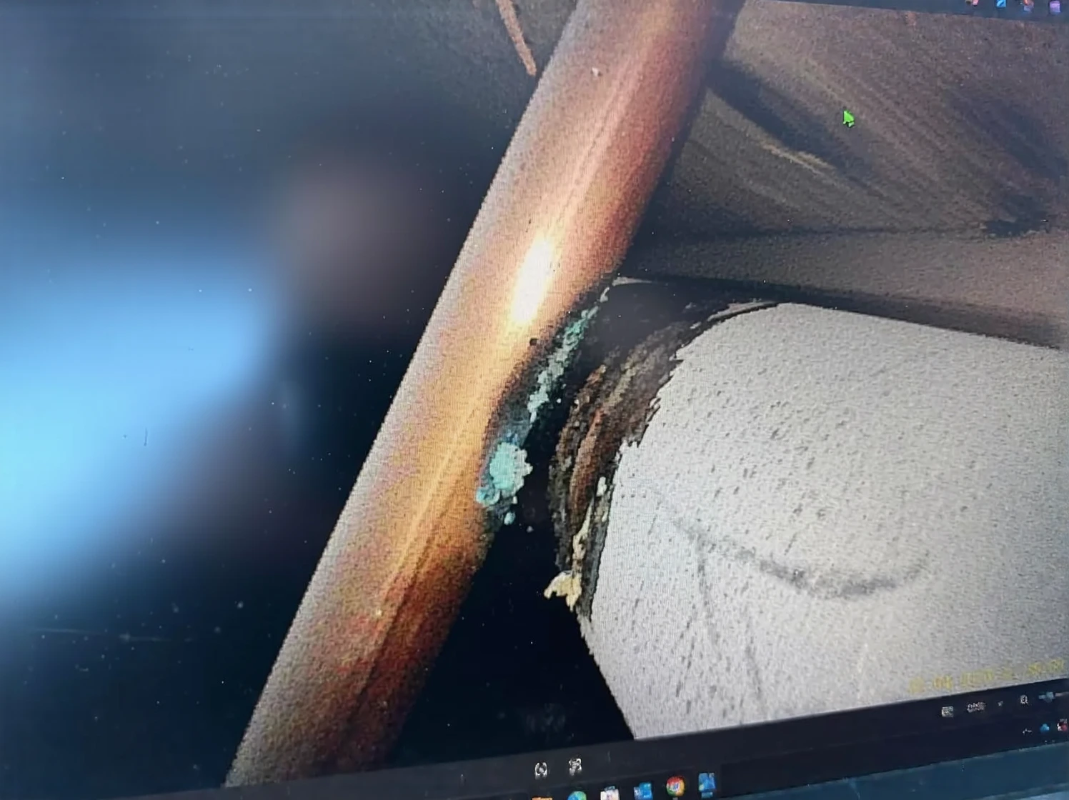 Real photo showing sediment and debris buildup inside septic tank after 20 years
