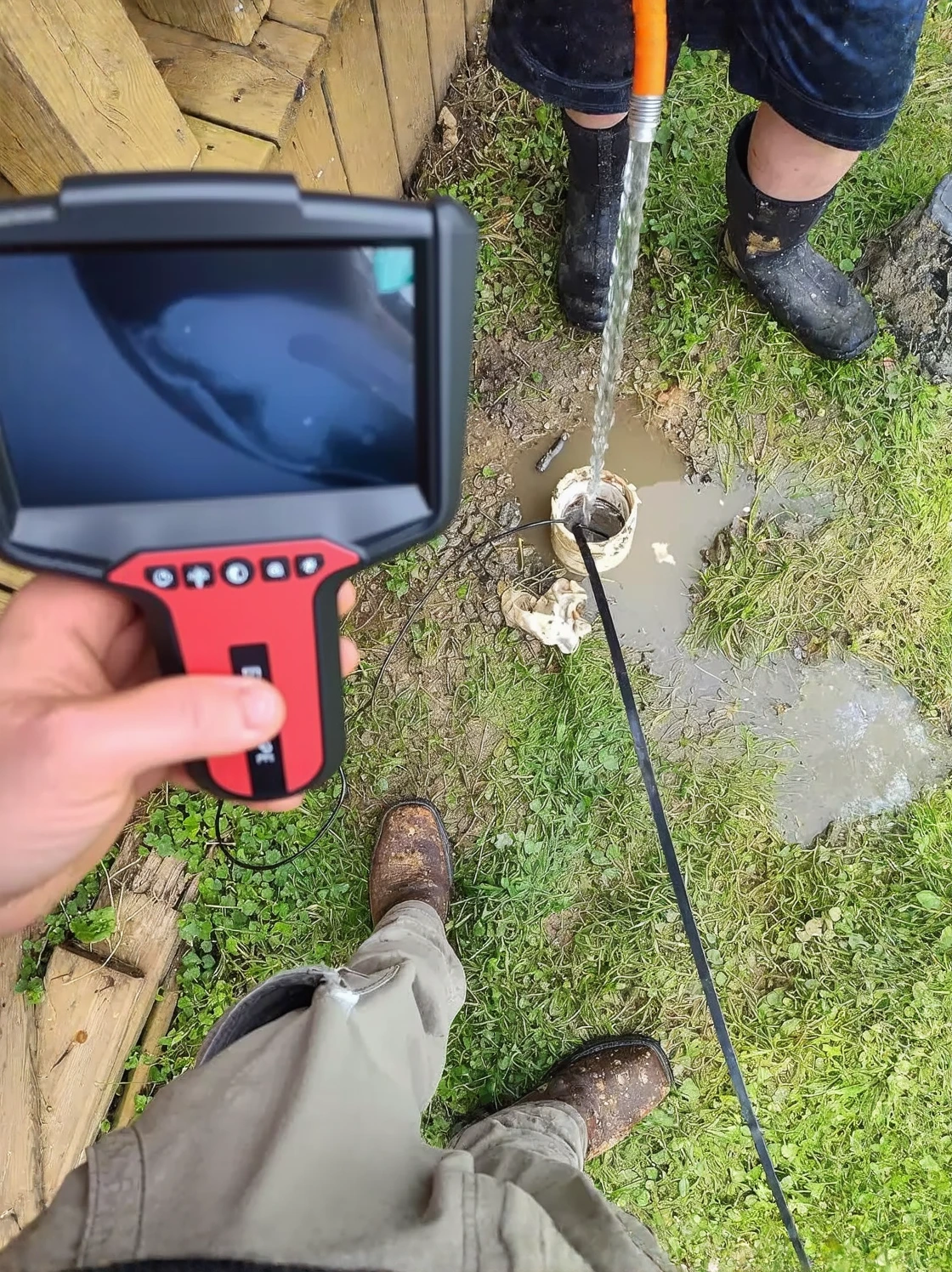 Customer photo of soggy yard area with water pooling near foundation