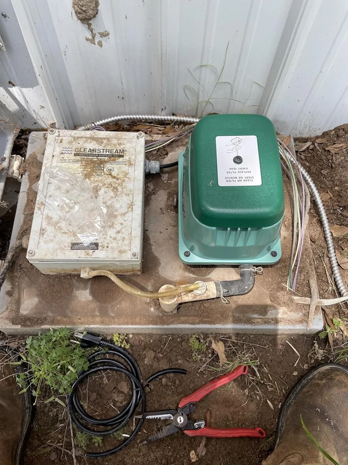 Customer photo of septic air pump replacement components laid out for installation