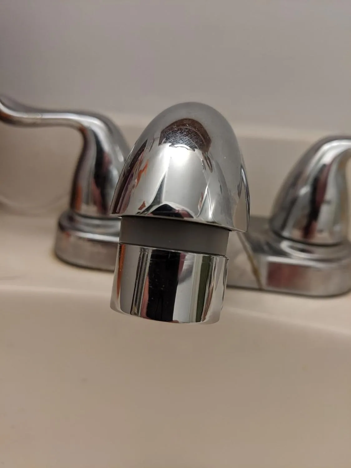 Customer photo of low-flow showerhead installed in bathroom showing water pressure reduction