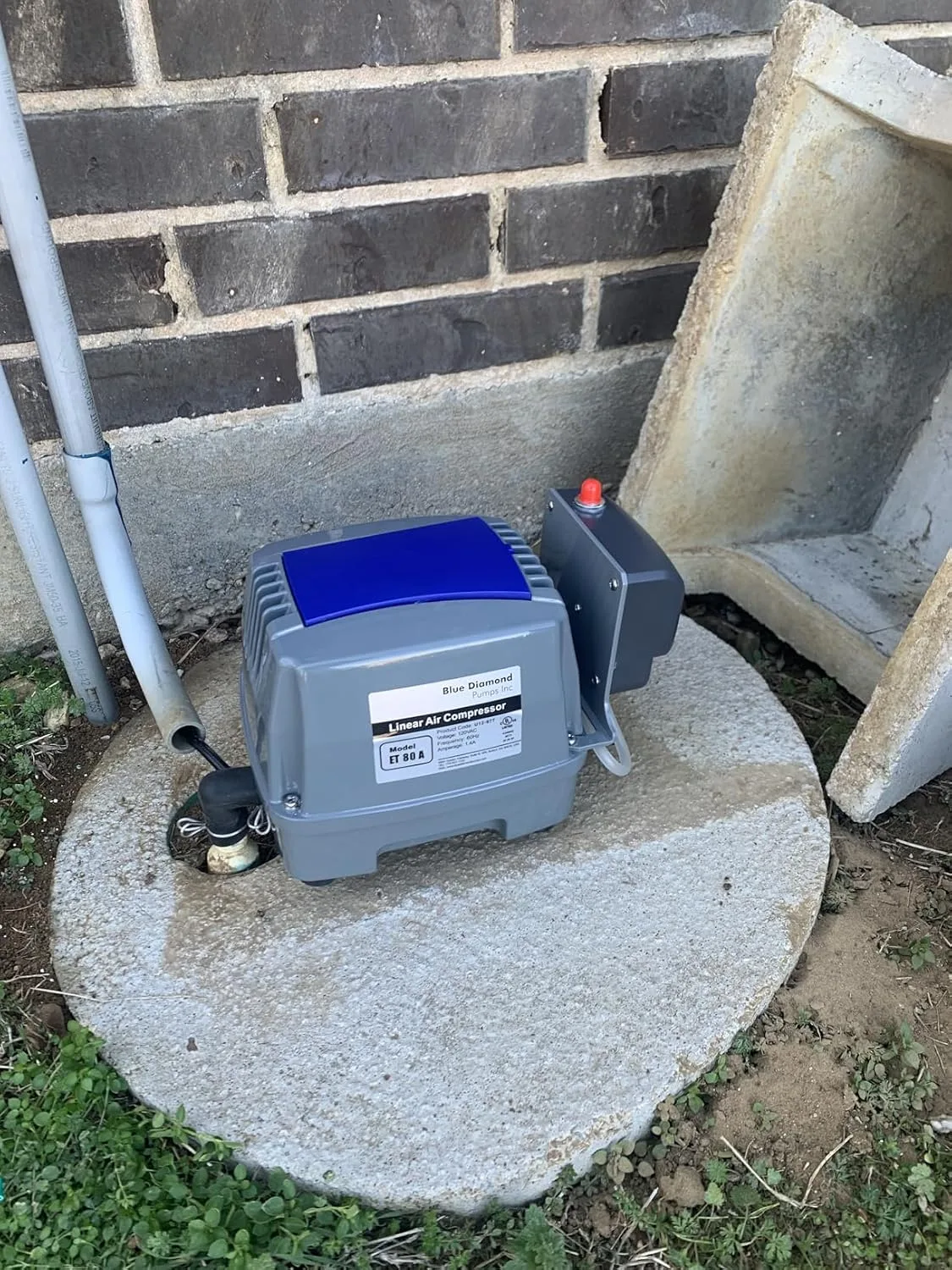 Customer photo of aerobic system air pump showing the pump unit and tubing components